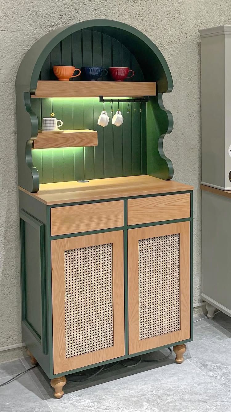 Green and wood coffee station with arched shelving, LED lighting, and cane-front cabinet doors.