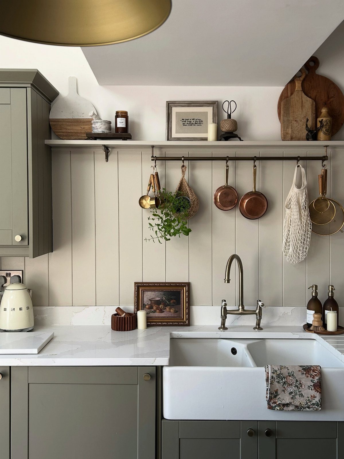 Vertical tongue and groove wood paneling serves as a backsplash in a rustic kitchen setting.