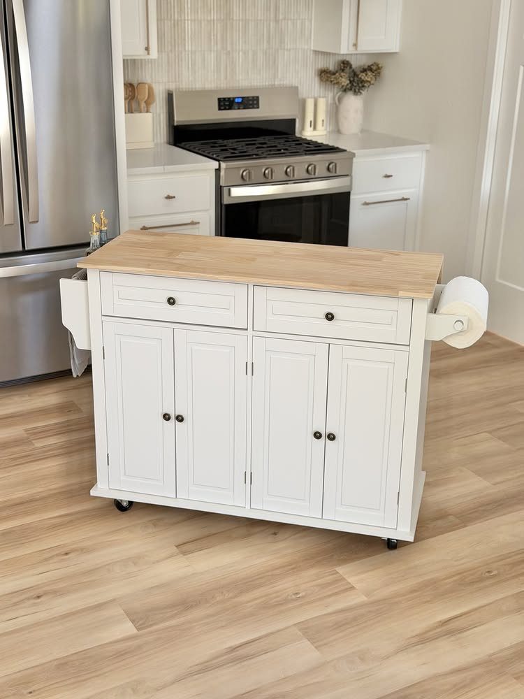 A white mobile kitchen island with a butcher block countertop and storage cabinets on a wood floor.