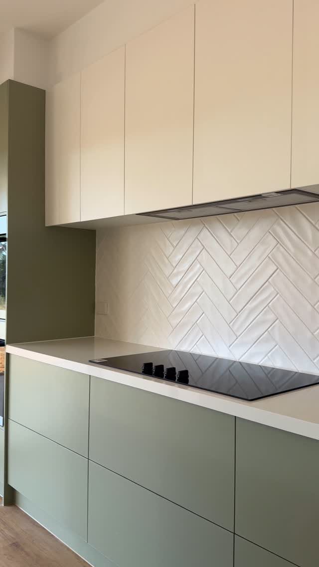Green Kitchen Cabinets: 12 Ideas for Every Shade 11 Light sage green kitchen cabinets with white herringbone tile backsplash and cream upper cabinets.