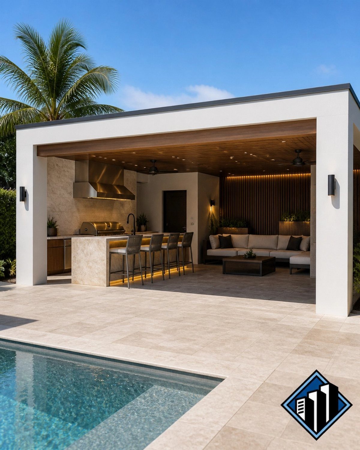 Modern outdoor kitchen and bar area with stone counters and lounge seating next to a pool.