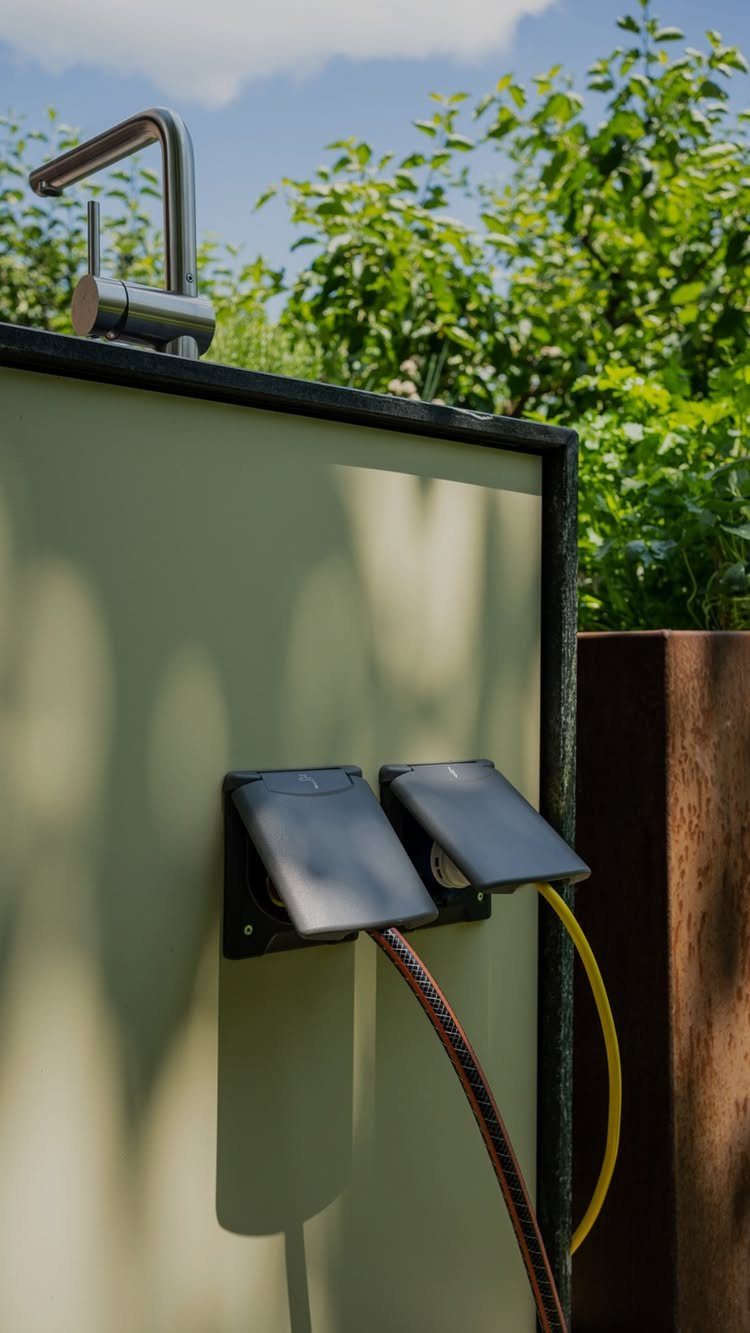 Two outdoor electrical outlets with protective covers mounted on a light-colored kitchen cabinet.