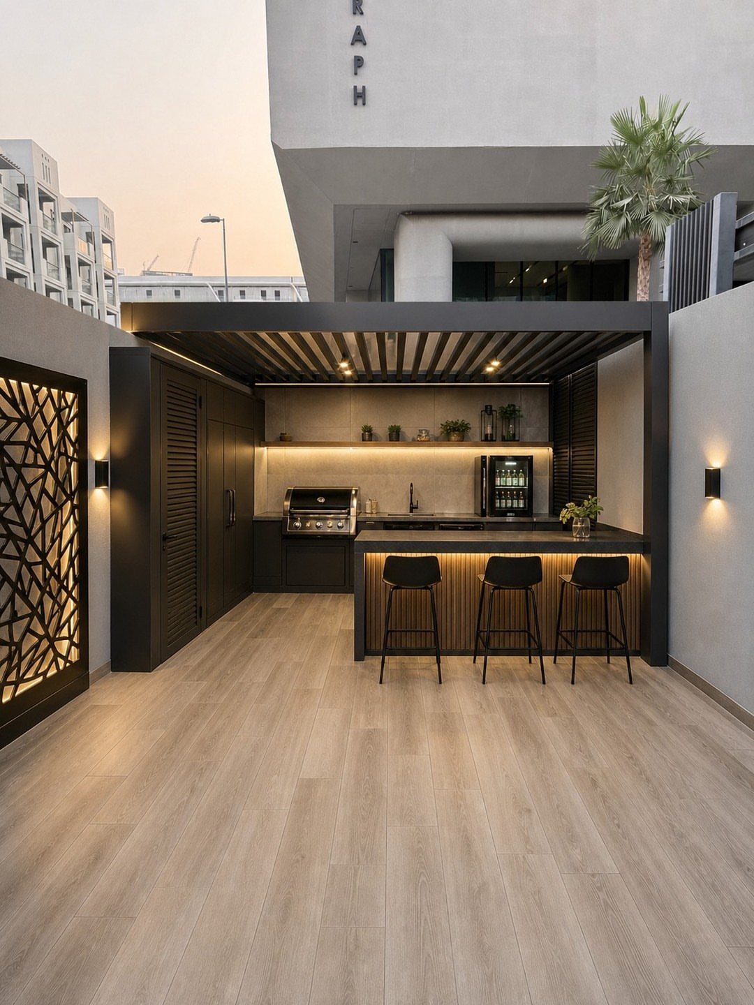 Modern black outdoor kitchen with a built-in grill and bar seating under a slatted pergola.