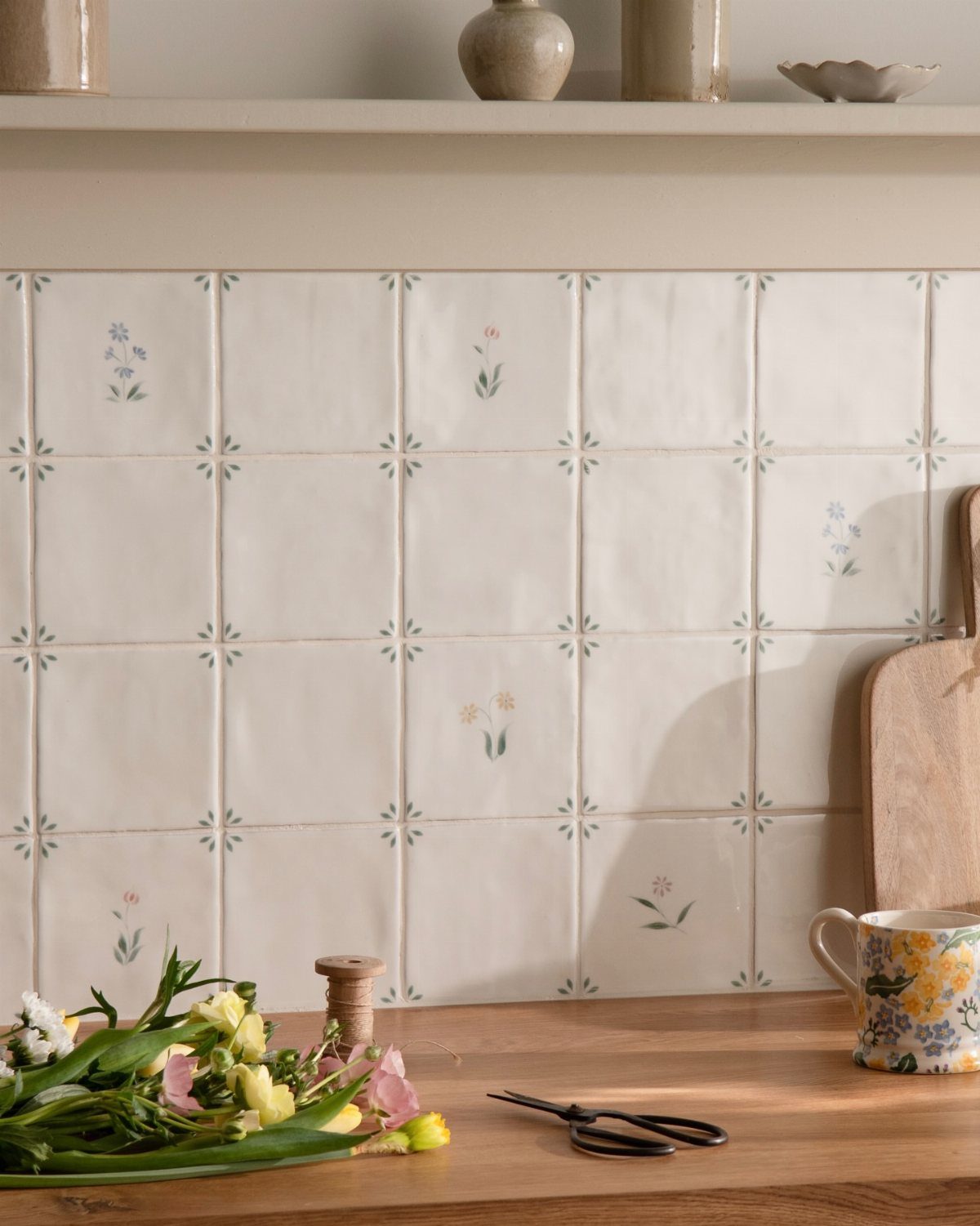Hand-painted ceramic tiles with small floral patterns on a kitchen backsplash.