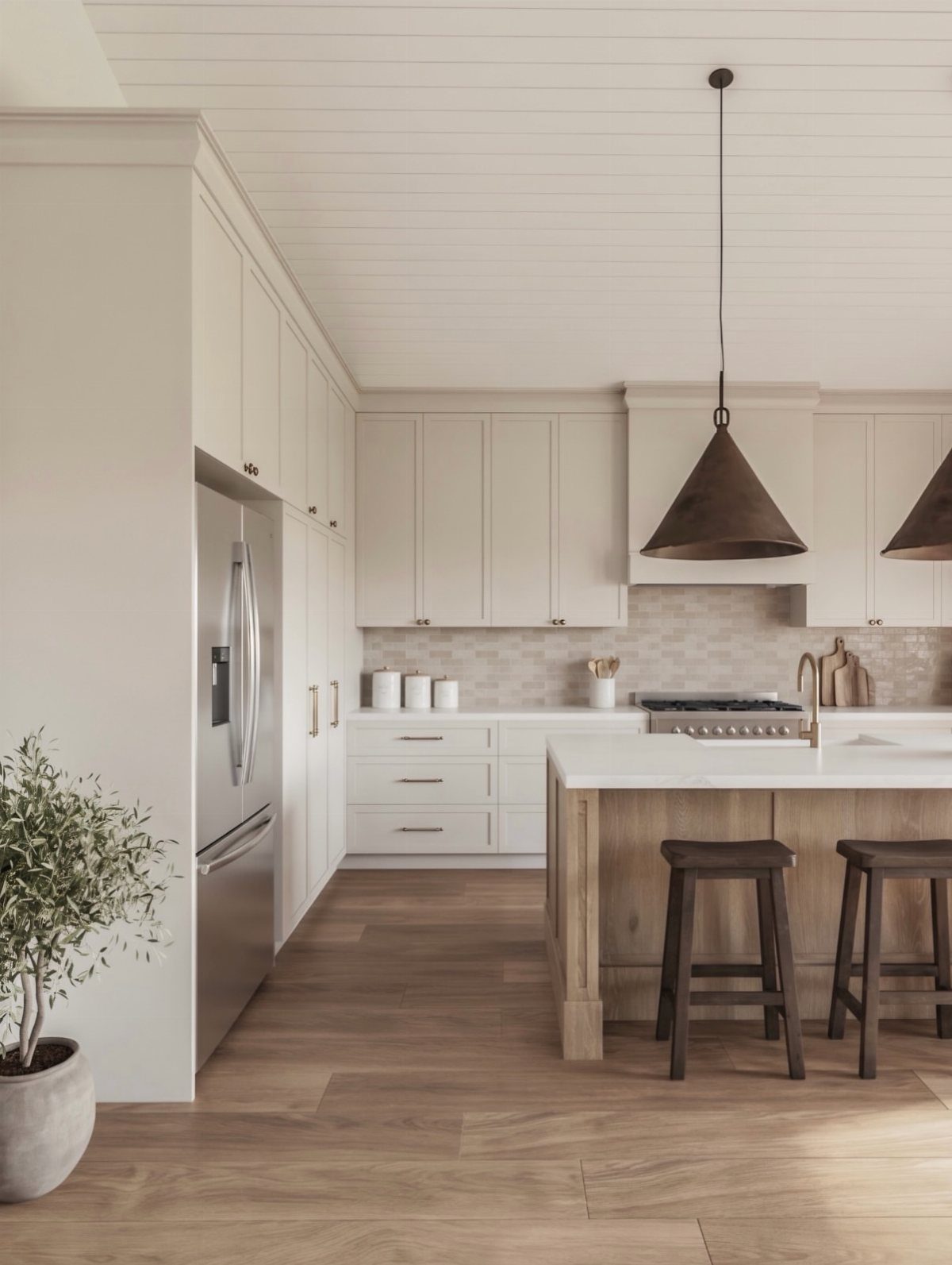 Modern kitchen with white cabinetry, a light wood island, and dark metal pendant lights hanging above.